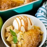 Apple cobbler served with vanilla ice cream and caramel sauce.