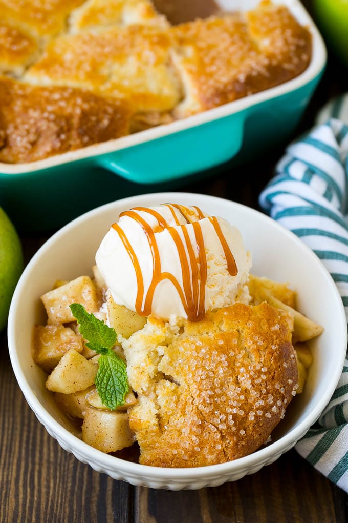 Apple cobbler served with vanilla ice cream and caramel sauce.