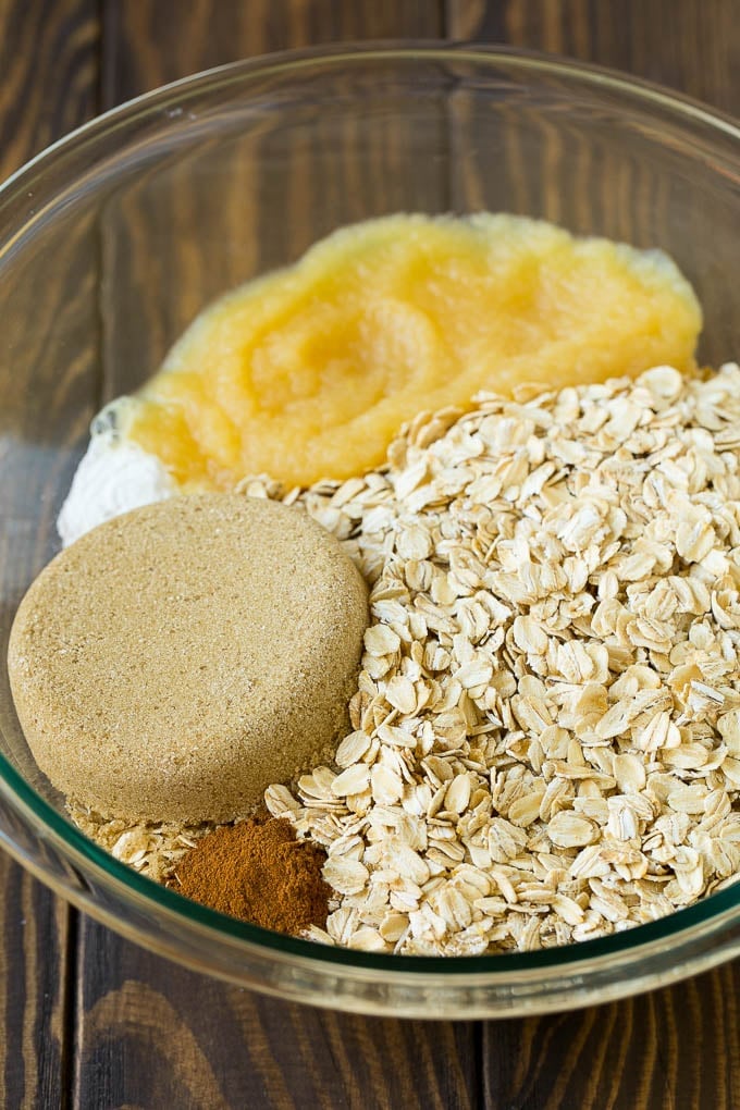 Oatmeal, applesauce, brown sugar and cinnamon in a mixing bowl.