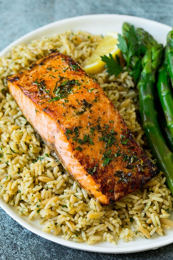 Broiled salmon served with rice and asparagus.