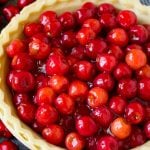 Cherry pie filling inside of an unbaked pie crust.