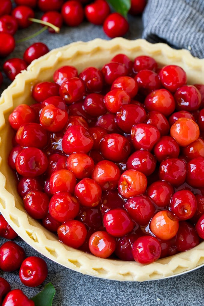 Cherry pie filling inside of an unbaked pie crust.