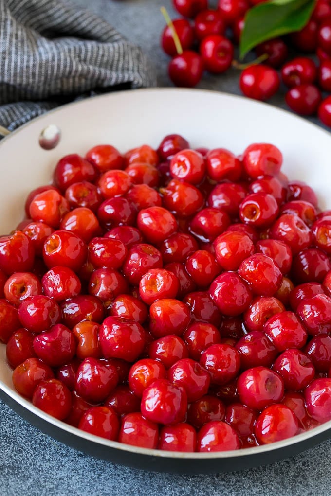 Cooked cherries in a skillet.