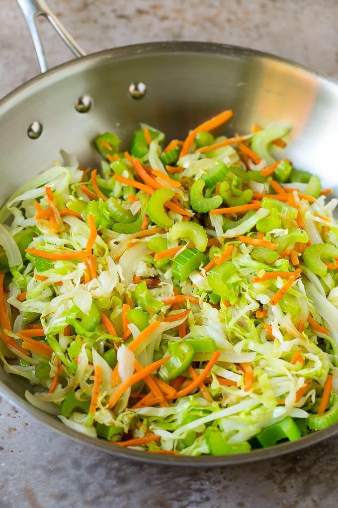 Cabbage, carrots and celery cooked in a pan.