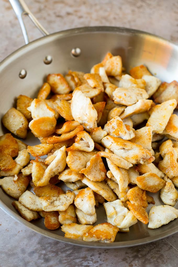Sauteed chicken in a skillet.