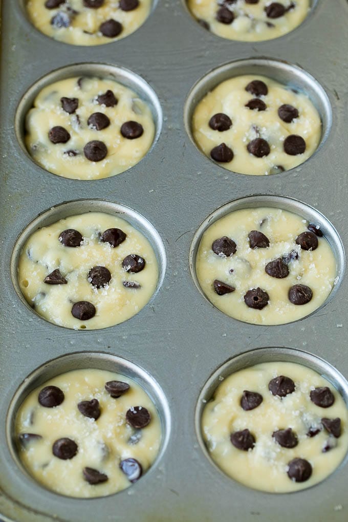 Chocolate muffin batter poured into muffin tins.
