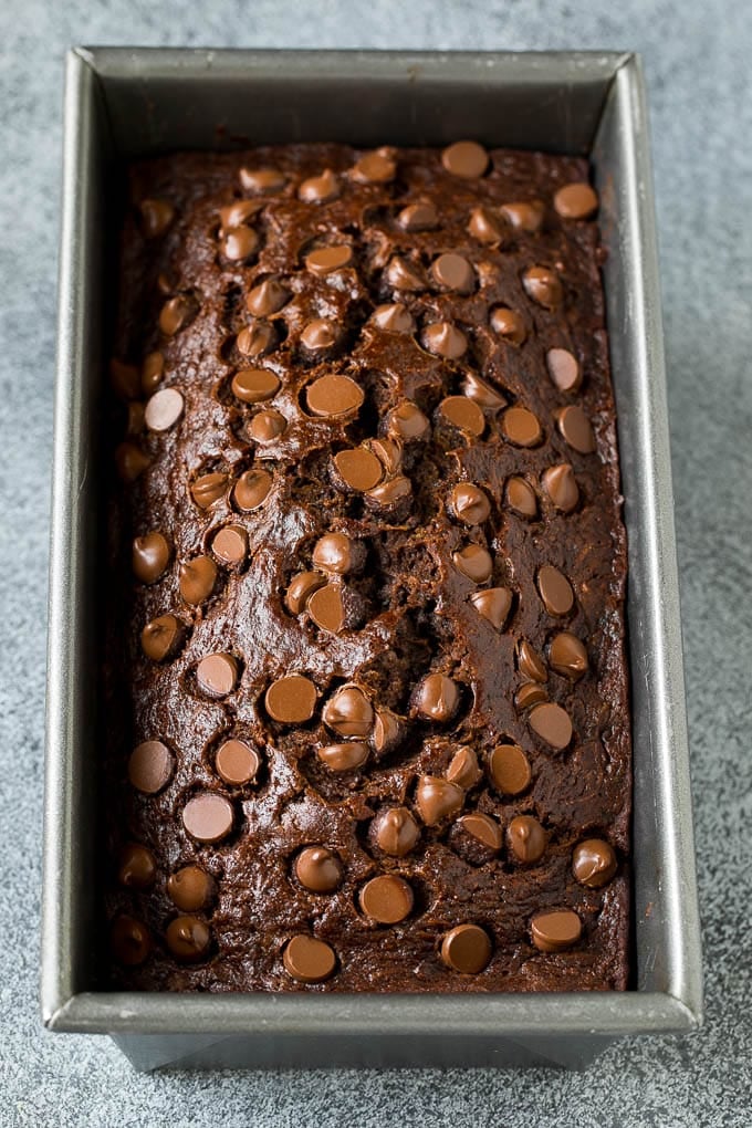 A loaf of chocolate bread topped with semisweet chocolate.