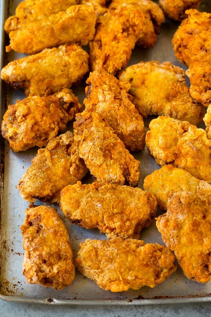 Deep fried wings on a sheet pan.