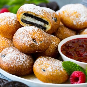 A plate of fried Oreos with one cut open.