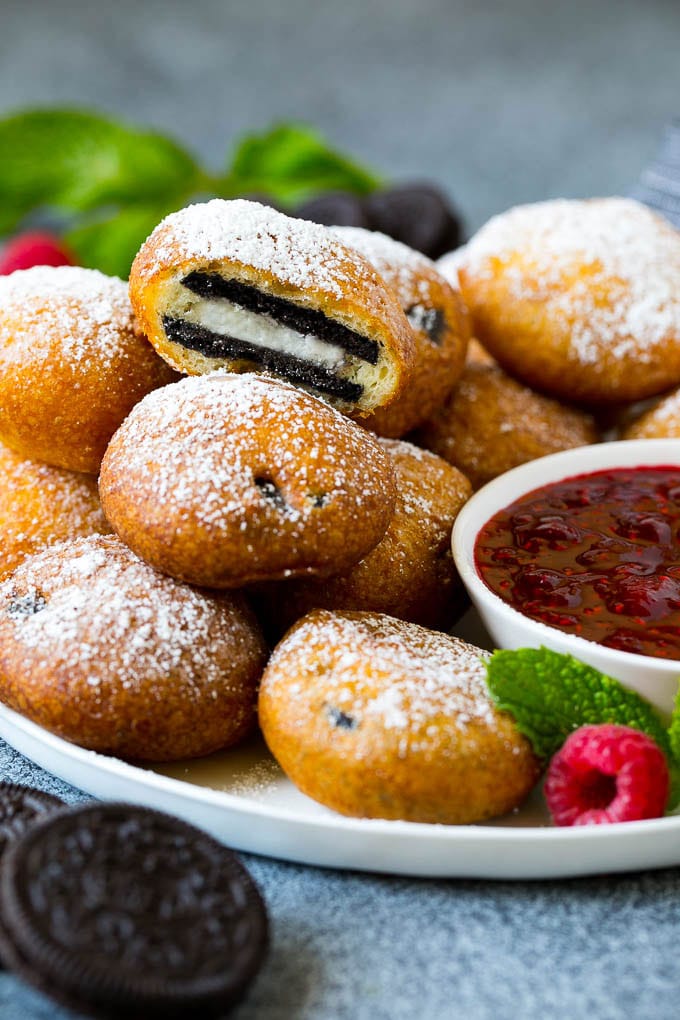 A plate of fried Oreos with one cut open.