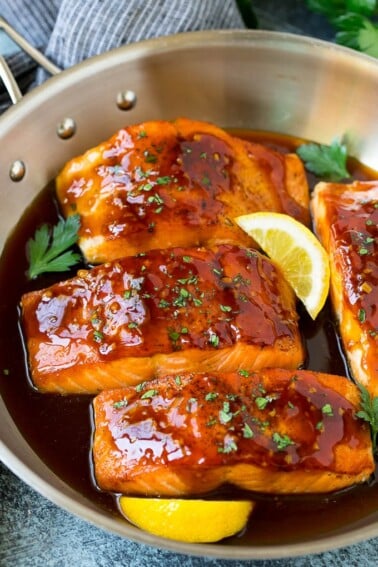 Honey glazed salmon garnished with parsley and lemon.