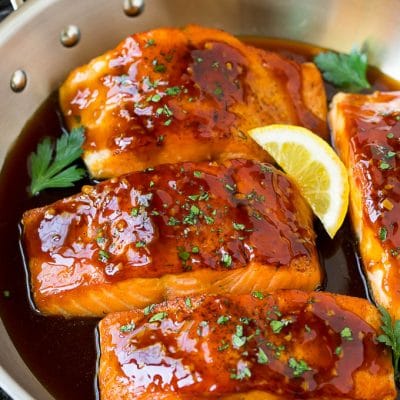 Honey glazed salmon garnished with parsley and lemon.