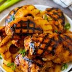 A plate full of huli huli chicken and grilled pineapple.