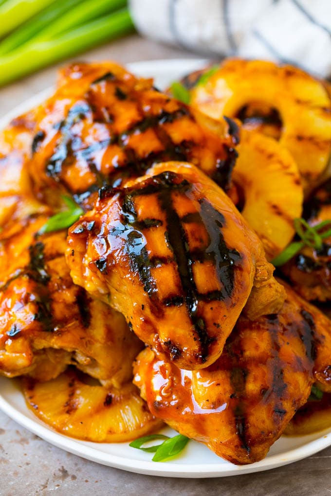 A plate of grilled huli huli chicken and pineapple.