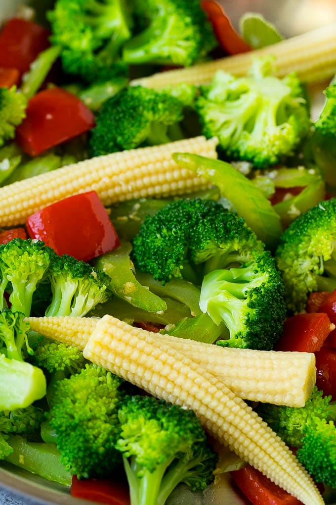 Broccoli, corn and bell peppers in a skillet.