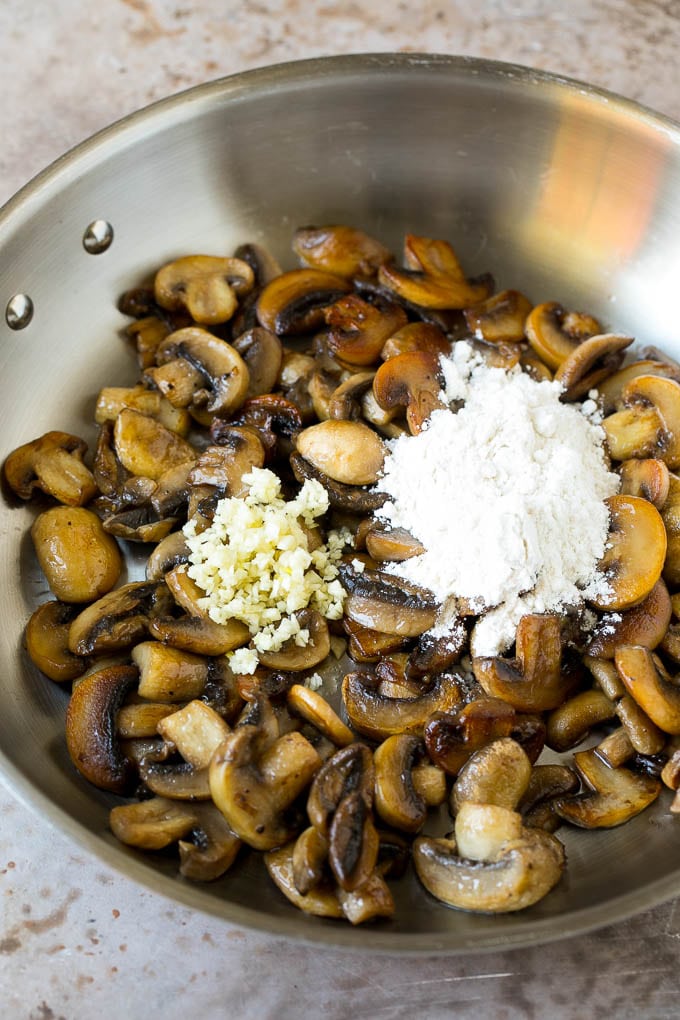 Mushrooms with fresh garlic and flour in a pan.