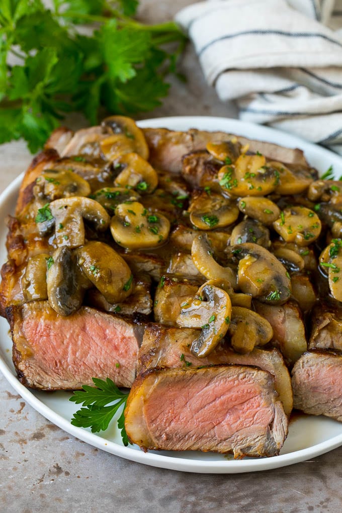 Sliced meat with mushroom steak sauce poured over the top.