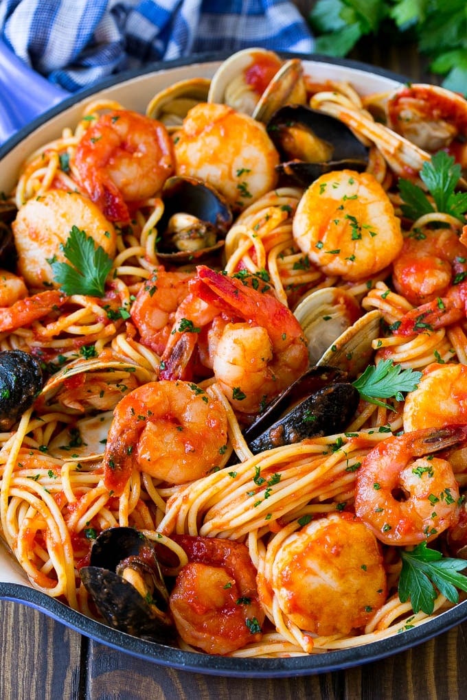 A skillet of seafood pasta with spaghetti, shrimp and shellfish.