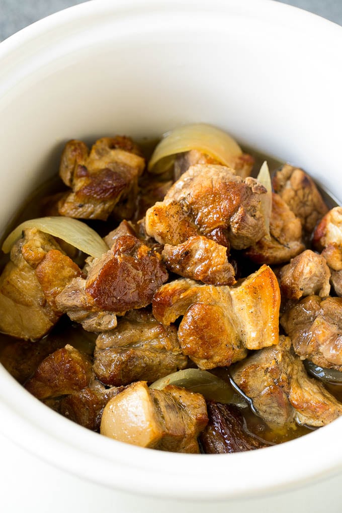 A crock pot fillled with pork carnitas.