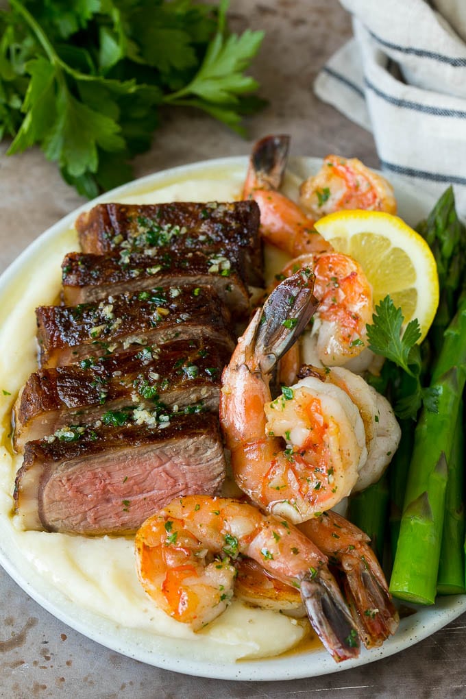 Surf and turf with steak, shrimp, mashed potatoes and asparagus.