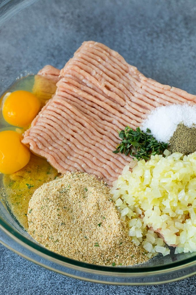 Ground turkey, seasonings, breadcrumbs, onion and herbs in a mixing bowl.