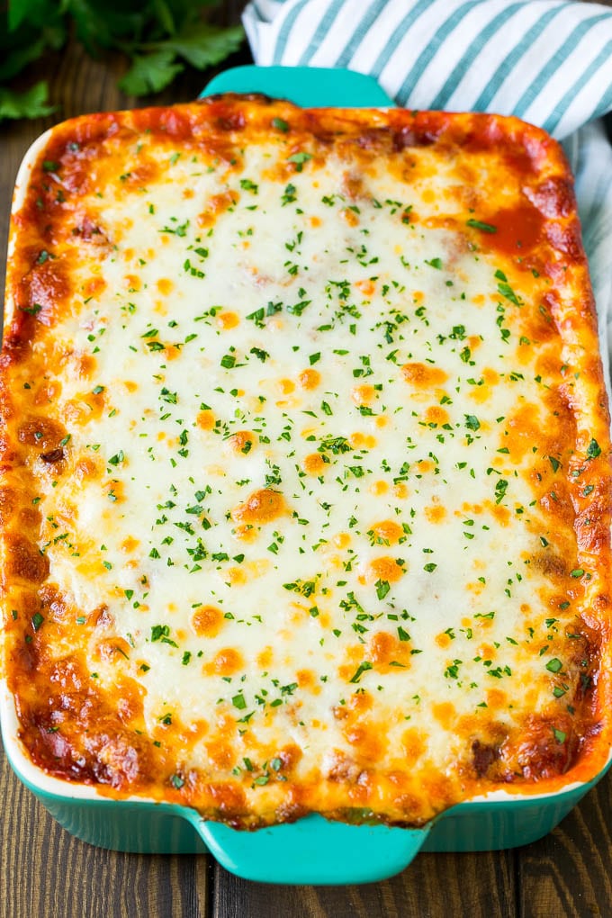 A baked zucchini lasagna topped with melted cheese and parsley.