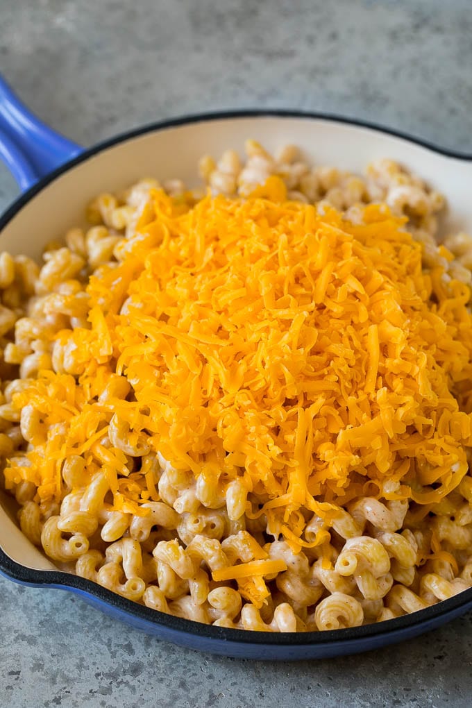 Pasta cooked in milk with shredded cheese on top.