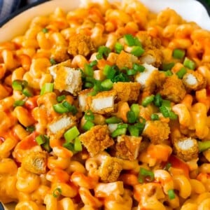 Buffalo chicken mac and cheese with crispy chicken pieces, celery and hot sauce.