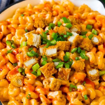 Buffalo chicken mac and cheese with crispy chicken pieces, celery and hot sauce.