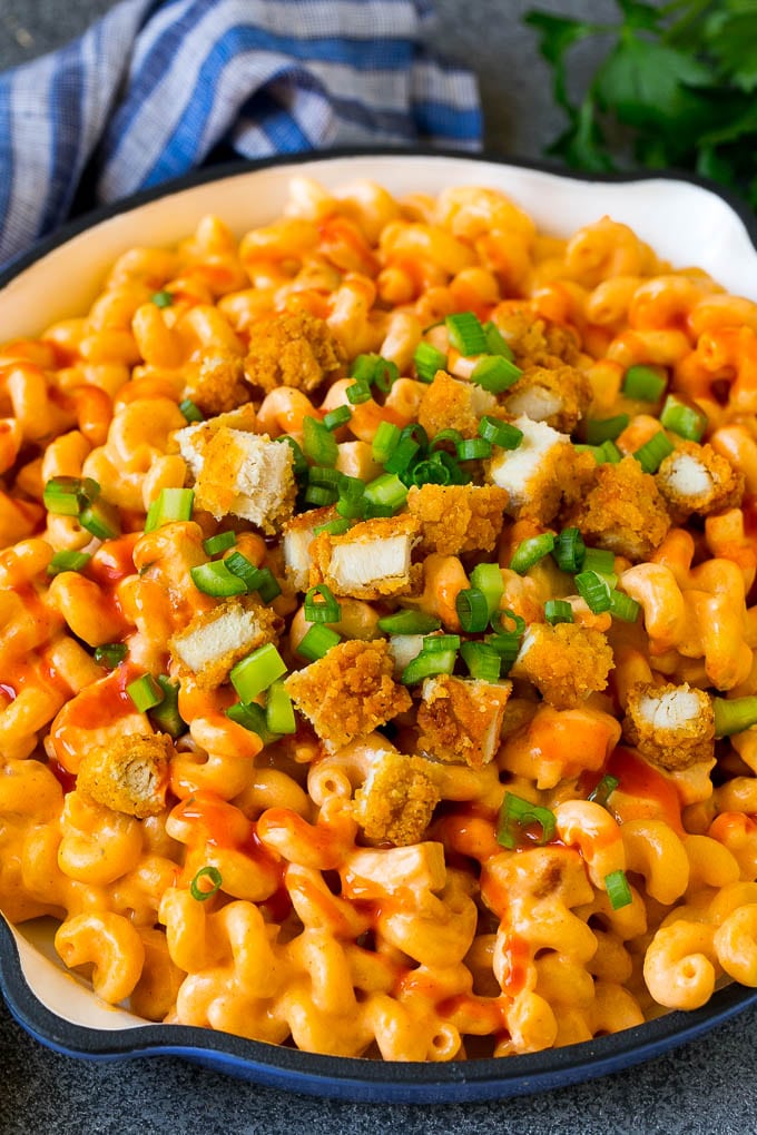 Buffalo chicken mac and cheese with crispy chicken pieces, celery and hot sauce.