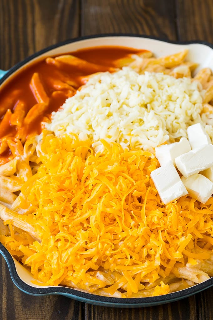 Cooked pasta topped with three cheeses and buffalo sauce.