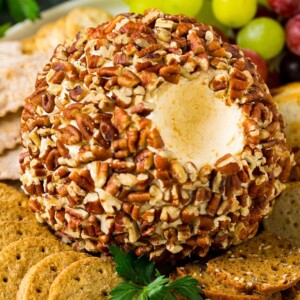 A cheese ball with a serving scooped out.