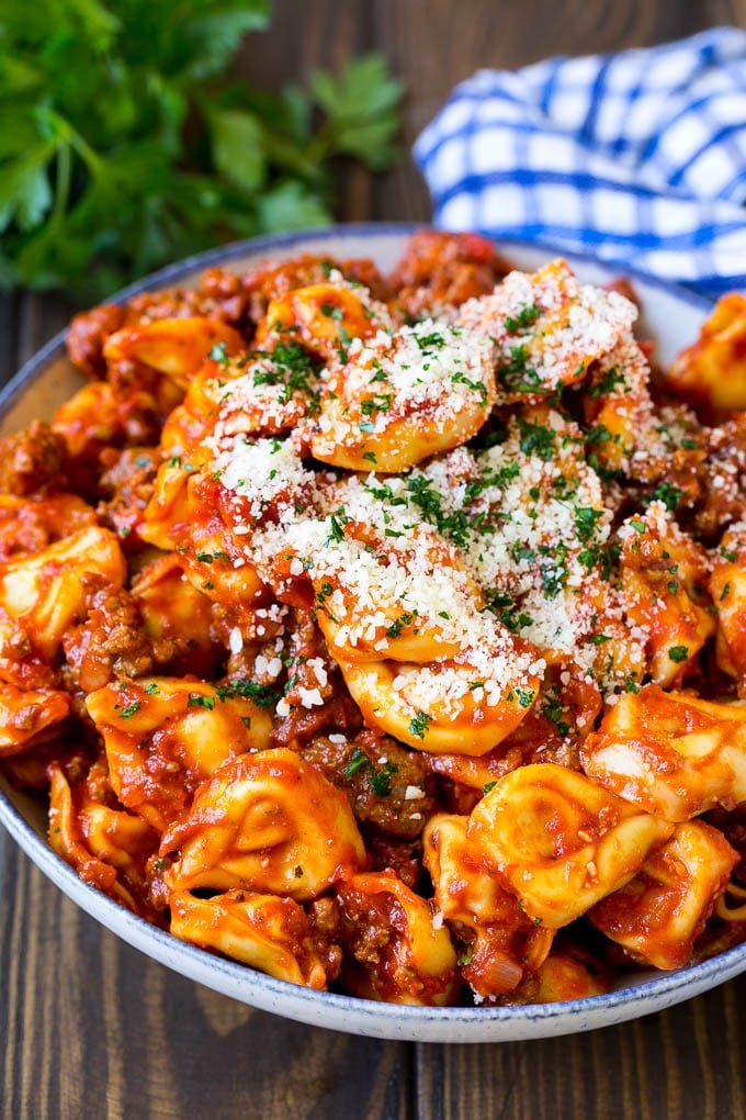 Cheese tortellini in homemade meat sauce, topped with parsley and parmesan cheese.
