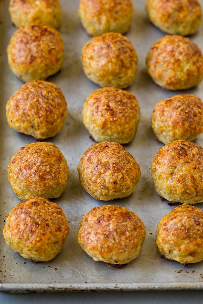 Baked meatballs on a sheet pan.