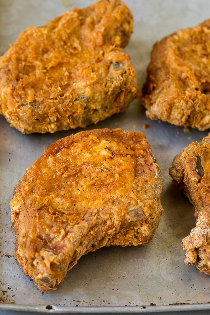 Crispy pork chops on a sheet pan.