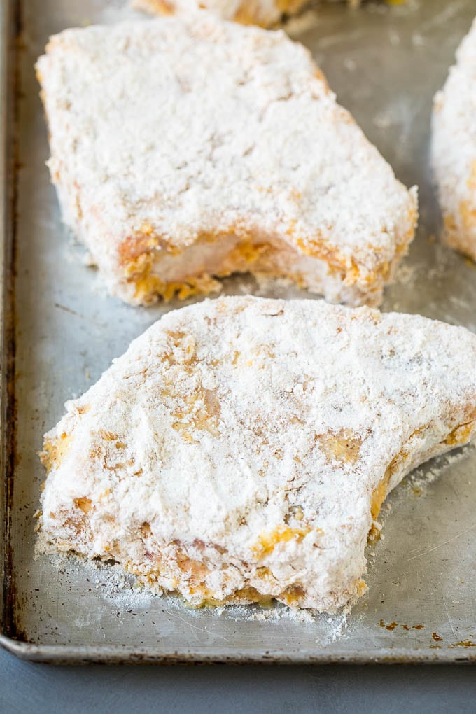 Pork chops dredged in flour and eggs.