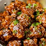 General Tso's chicken coated in a sweet and spicy sauce, then topped with sesame seeds.