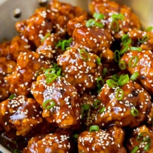 General Tso's chicken coated in a sweet and spicy sauce, then topped with sesame seeds.