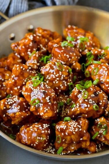 General Tso's chicken coated in a sweet and spicy sauce, then topped with sesame seeds.