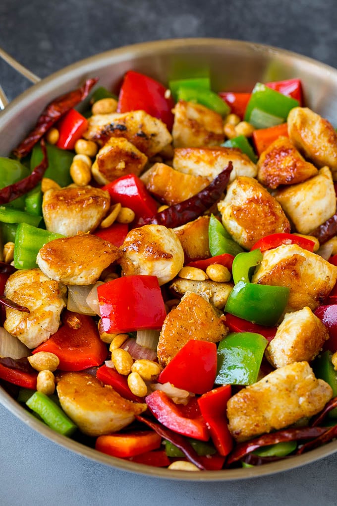 Chicken, beanuts, bell peppers and chilies all cooked together in a skillet.