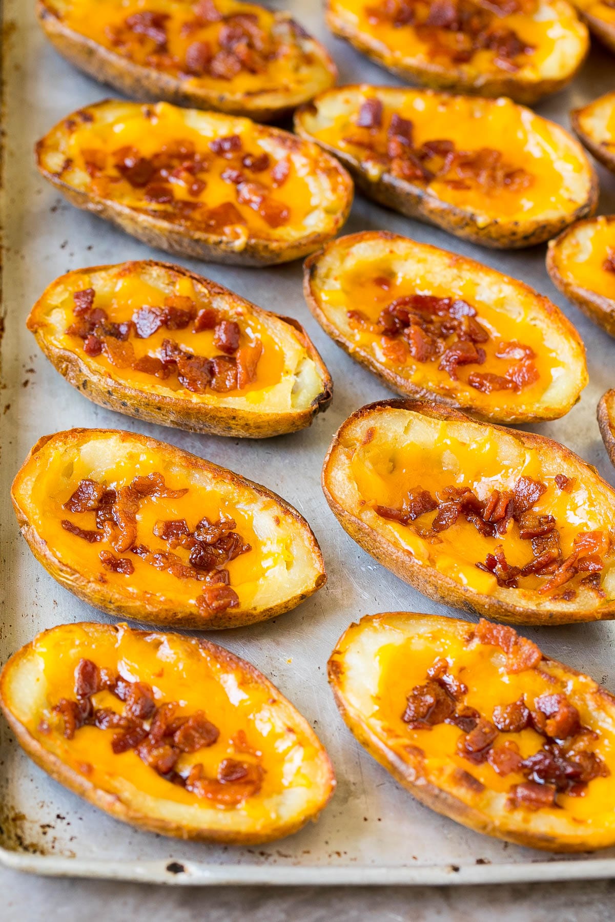 Potato halves topped with bacon and cheese.