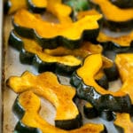 Roasted acorn squash garnished with fresh parsley.