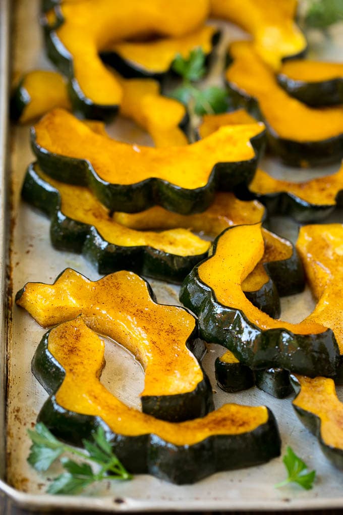 Roasted acorn squash garnished with fresh parsley.