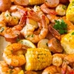 A pan of shrimp boil made with corn, potatoes and sausage.