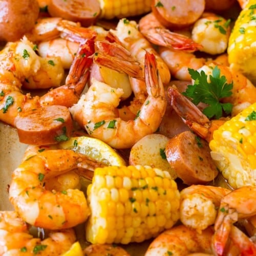 A pan of shrimp boil made with corn, potatoes and sausage.