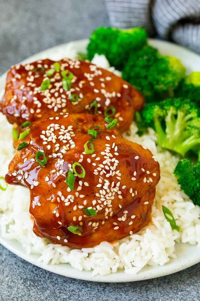 Slow cooker chicken thighs served with rice and broccoli.
