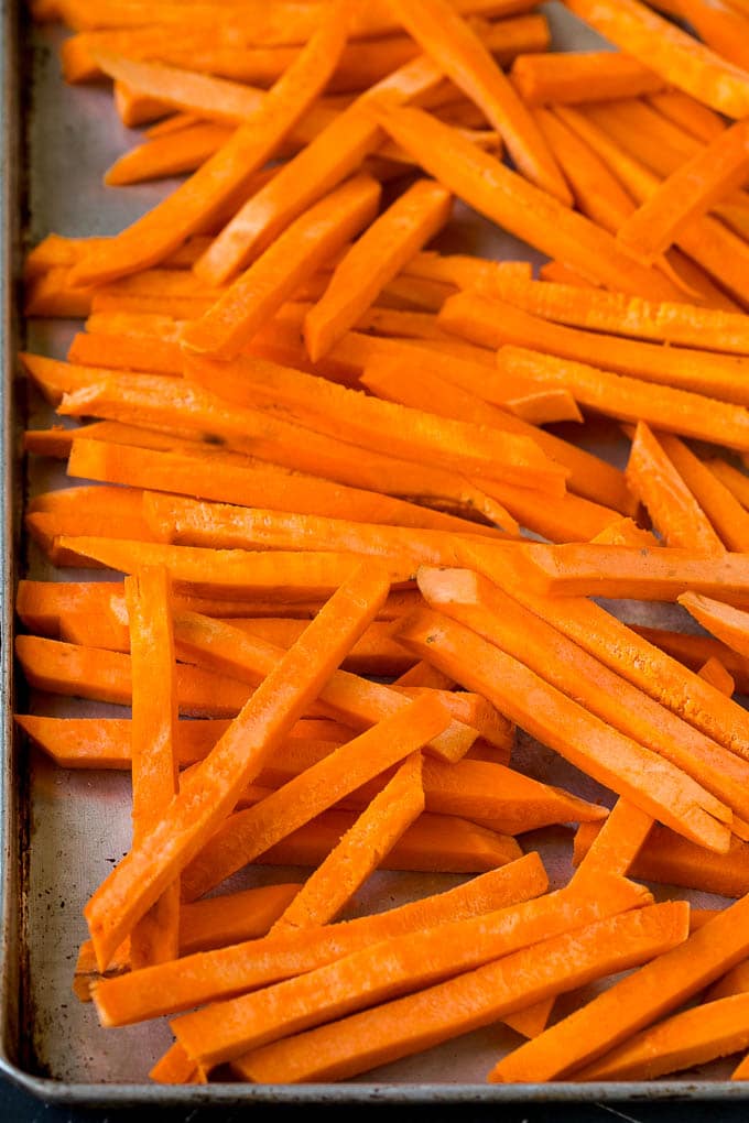 Cut sweet potatoes on a sheet pan.