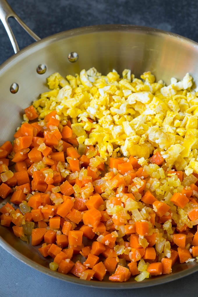 Scrambled eggs and mixed vegetables in a pan.
