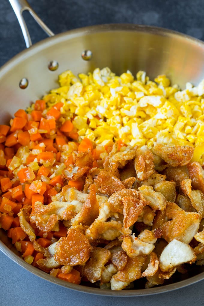 Thinly sliced cooked chicken with carrots and scrambled eggs.