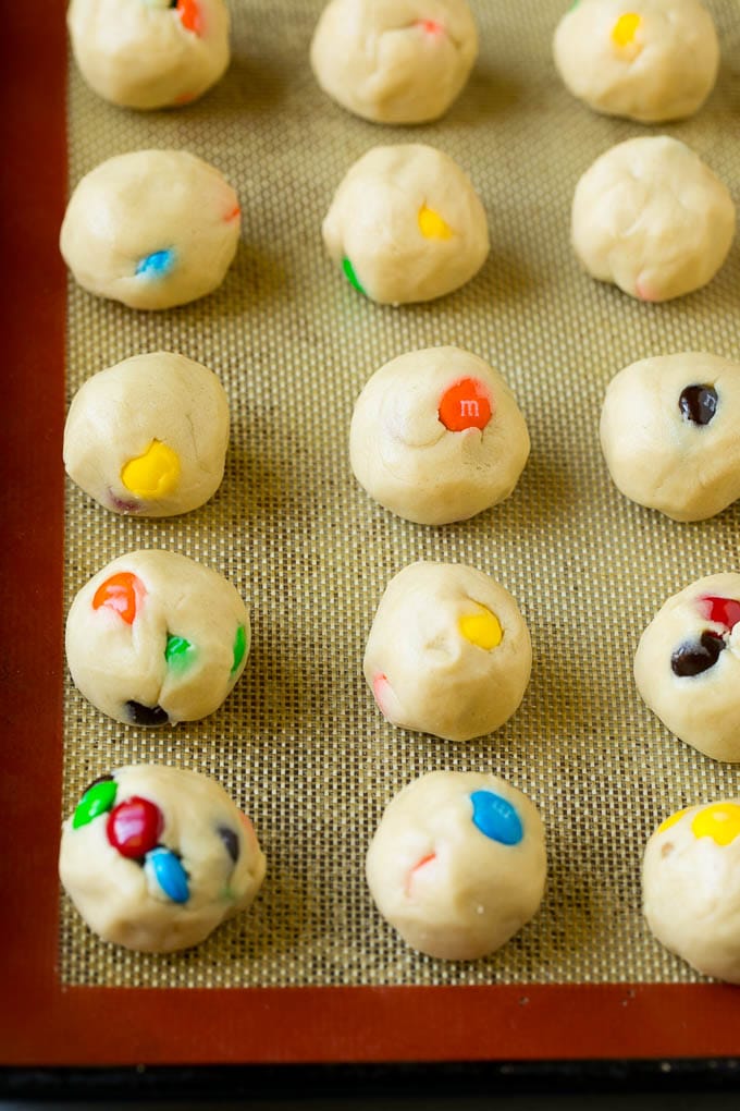 Balls of cookie dough on a baking sheet.